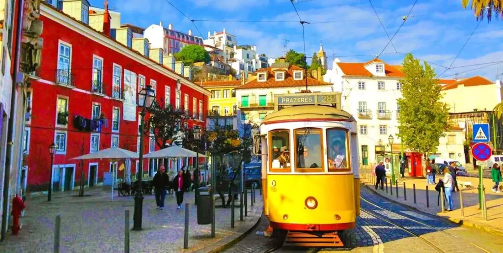 Where vintage trams climb colorful streets and the ocean breeze whispers history.